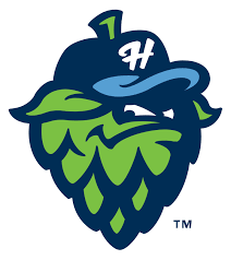 Hillsboro Hops logo: a smirking hop green bud wearing a blue baseball cap with a white letter "H" on it